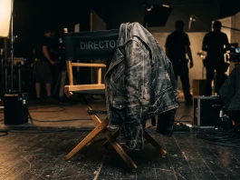 A leather jacket on a director's chair in a studio.