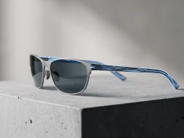 A conceptual visualization of slim, futuristic smart glasses and an external compute device.