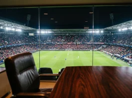 A professional football stadium seen from a high-end corporate office window.