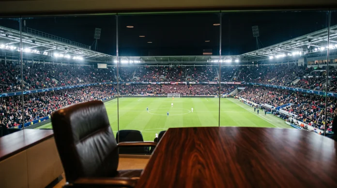 A professional football stadium seen from a high-end corporate office window.