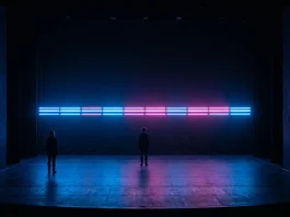 A minimalist stage design with neon lighting suggesting a desert horizon.