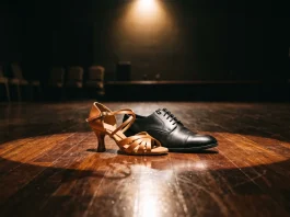 Professional ballroom dancing shoes on a stage floor.