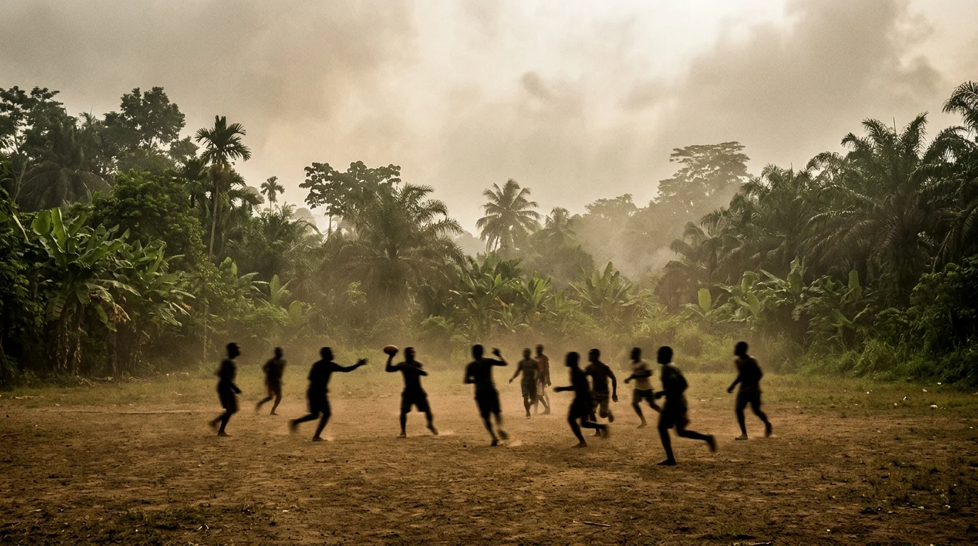 Silhouettes of men playing football on a tropical island field.
