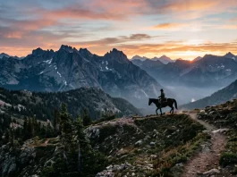 A silhouette of a cowboy on horseback against a Montana sunrise.