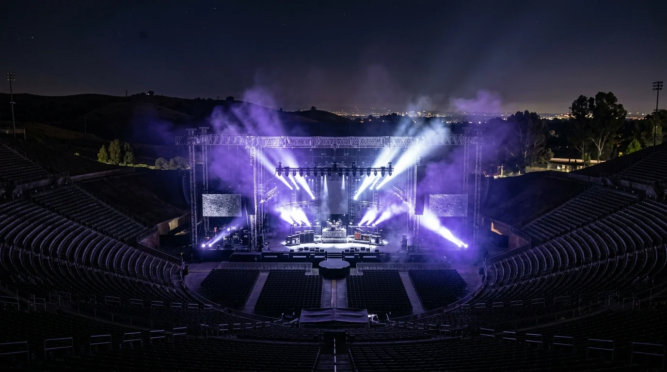 A conceptual view of a large outdoor concert stage with spotlights and purple lighting.