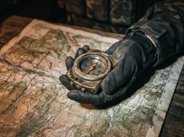 A tactical compass and map suggesting a military operation.