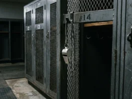 A silver whistle hanging in an empty locker room.